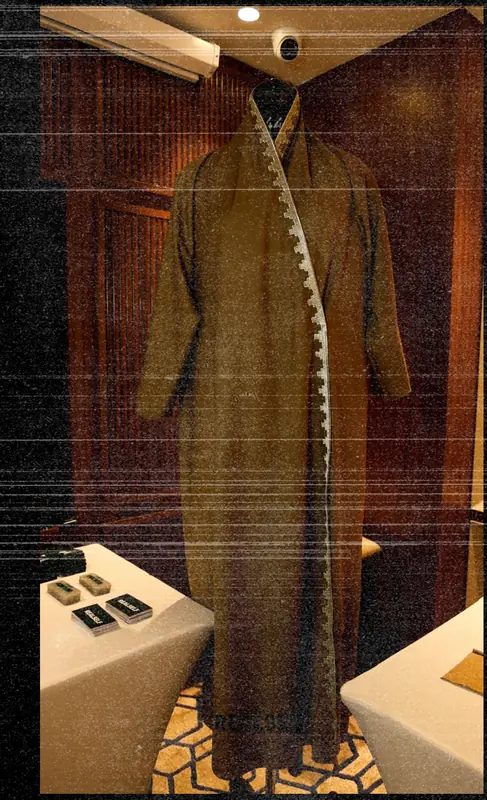 A front-of-house uniform coat displayed on a form inside the pavilion