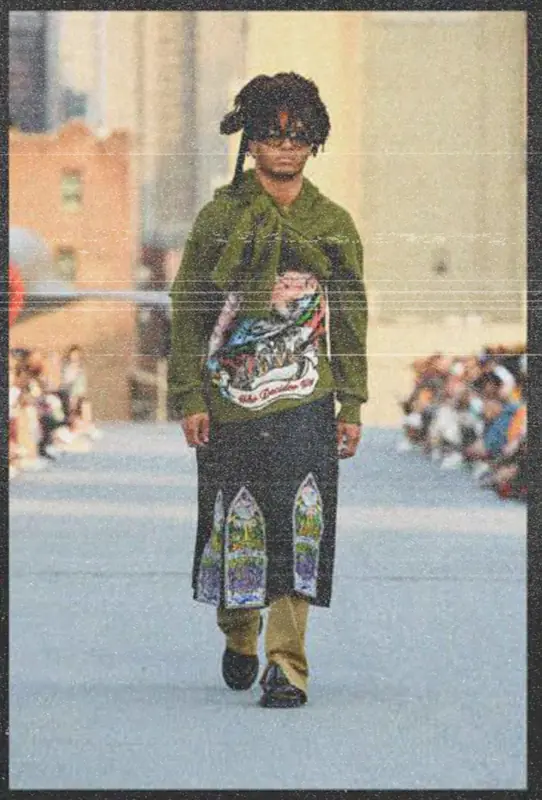 Model on the Intrepid runway in a hoodie with a stained-glass style panel